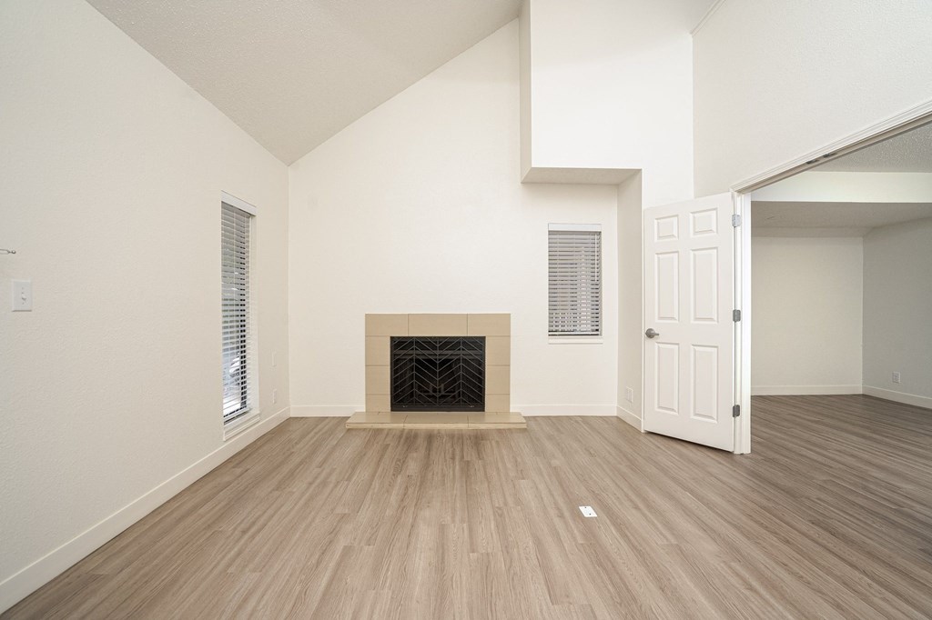 an empty living room with a fireplace